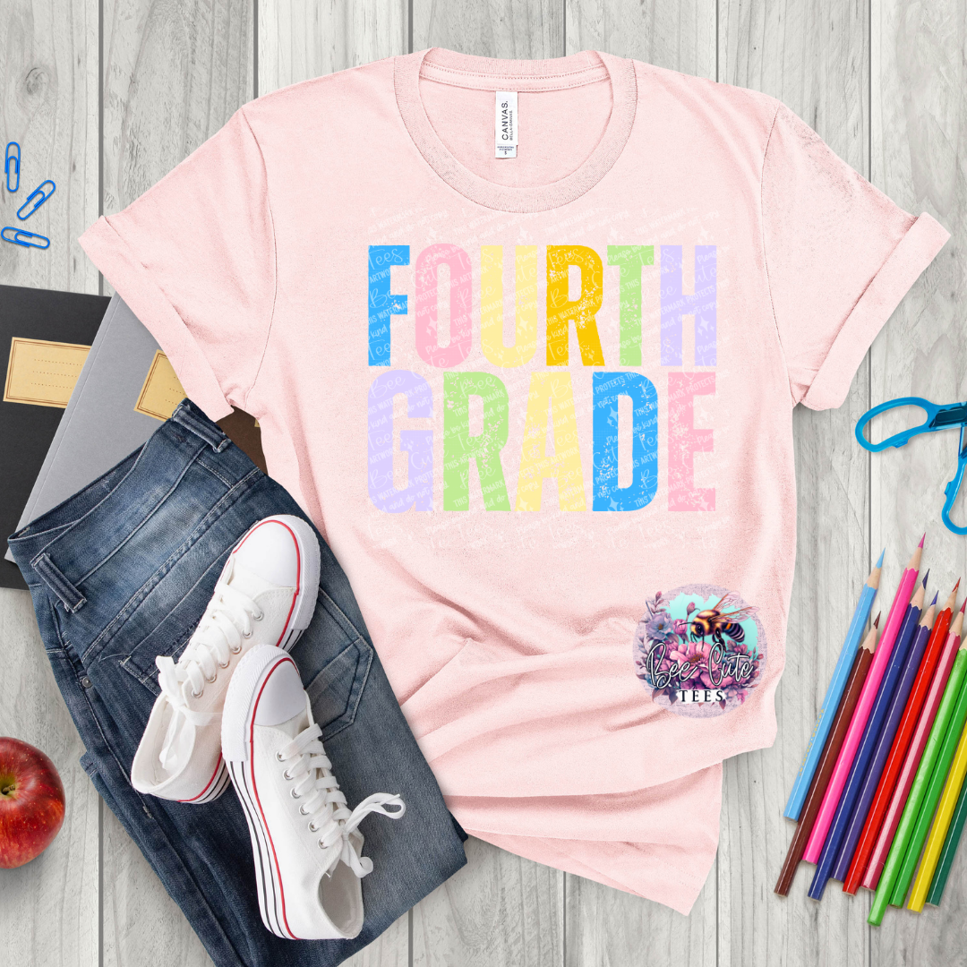 Pink t-shirt with 'FOURTH GRADE' in colorful letters, jeans, sneakers, and school supplies on a wooden surface.
