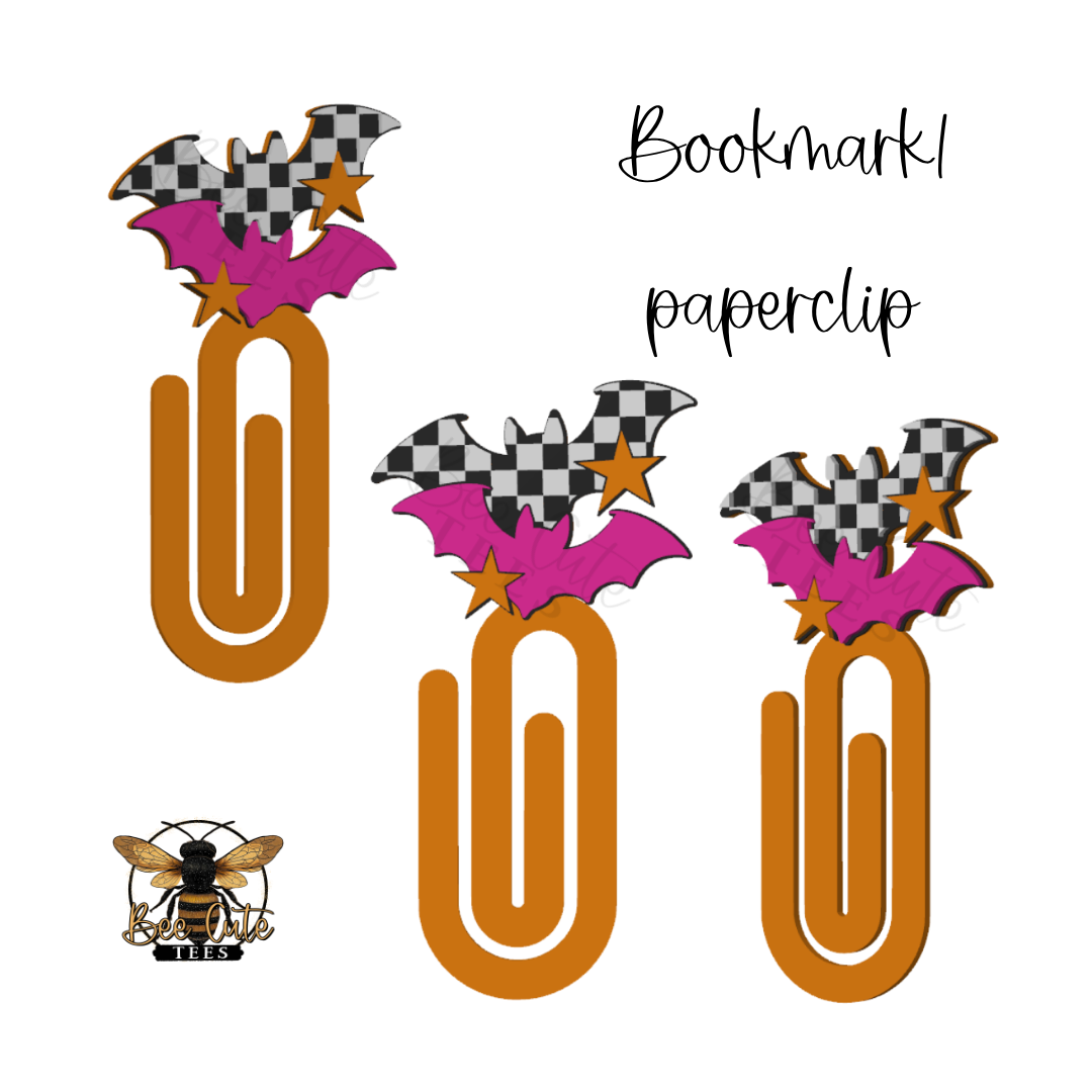 Three orange paperclip bookmarks decorated with pink bats, black-and-white checkered wings, and gold stars, shown on a white background with the words 'Bookmark paperclip' and a bee logo.