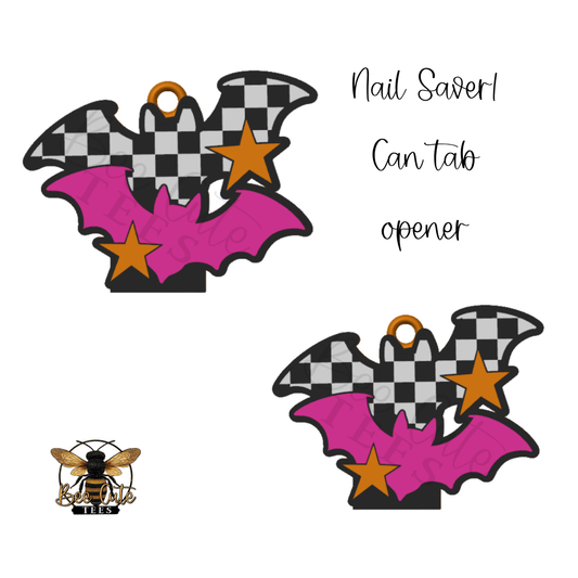 Two matching Halloween-themed nail savers shown on a white background, each shaped like a bat with black-and-white checkered wings, a bright pink body, orange stars, and a small gold hanging loop. Text on the right reads 'Nail Saver Can tab opener,' and a bee logo appears at bottom left.