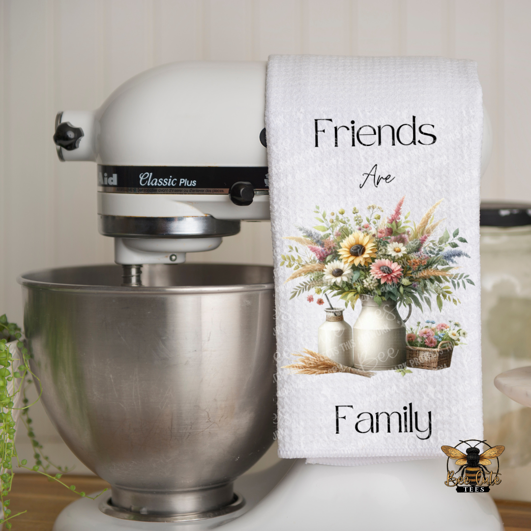 Kitchen mixer with a decorative towel featuring floral design and text in a kitchen setting