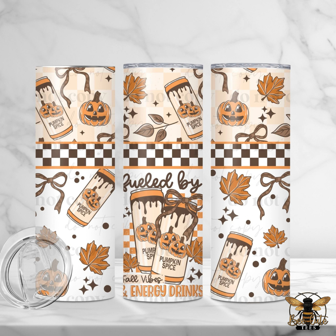 Three insulated tumblers with a fall-themed pumpkin and coffee mug pattern, shown on a white marble background with a clear lid in the foreground.