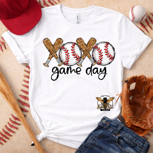 White t-shirt with baseball-themed design and accessories on a textured surface