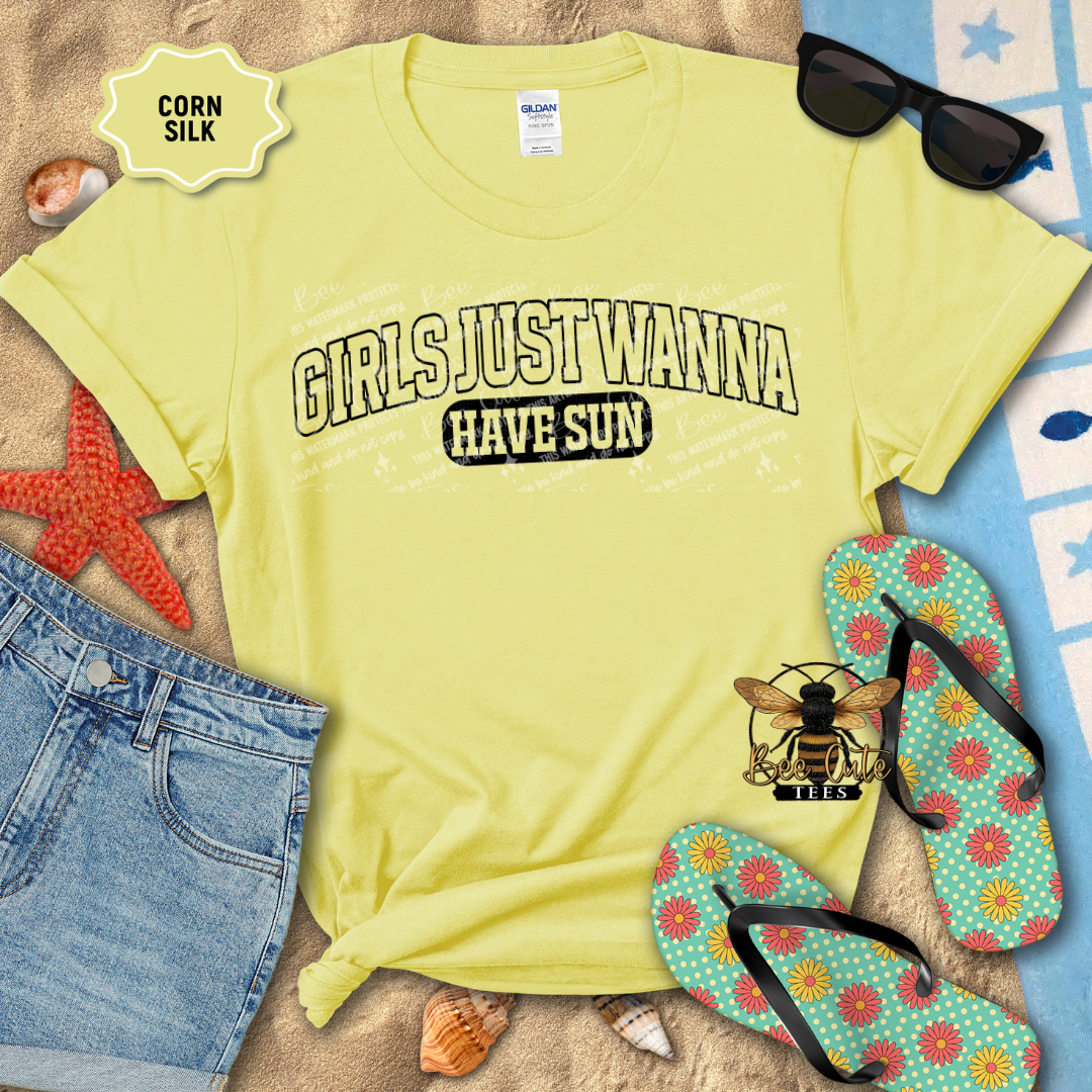 Yellow t-shirt with 'Girls Just Wanna Have Sun' text, sunglasses, and flip-flops on a beach-themed background.
