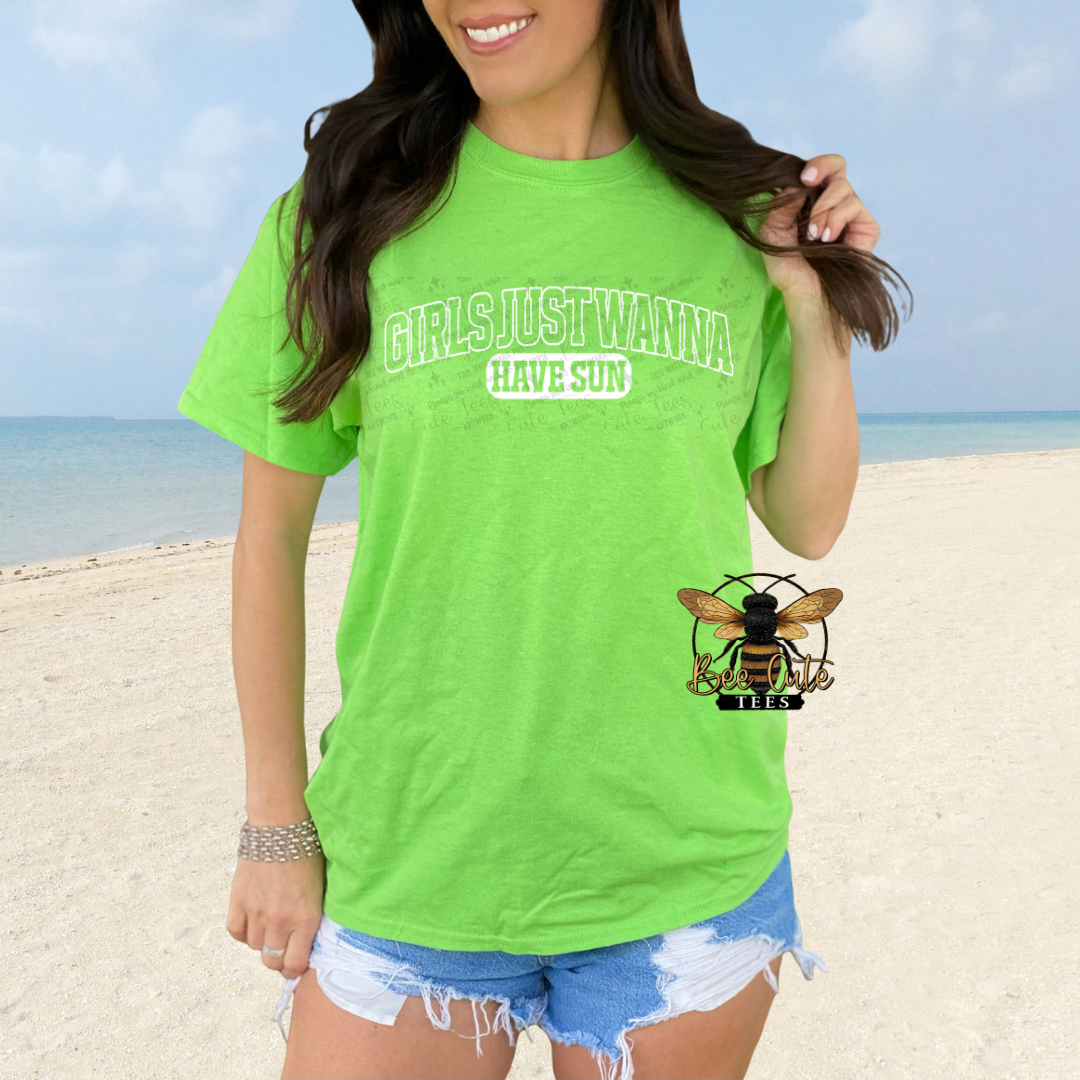 Person wearing a bright green t-shirt with text on a beach