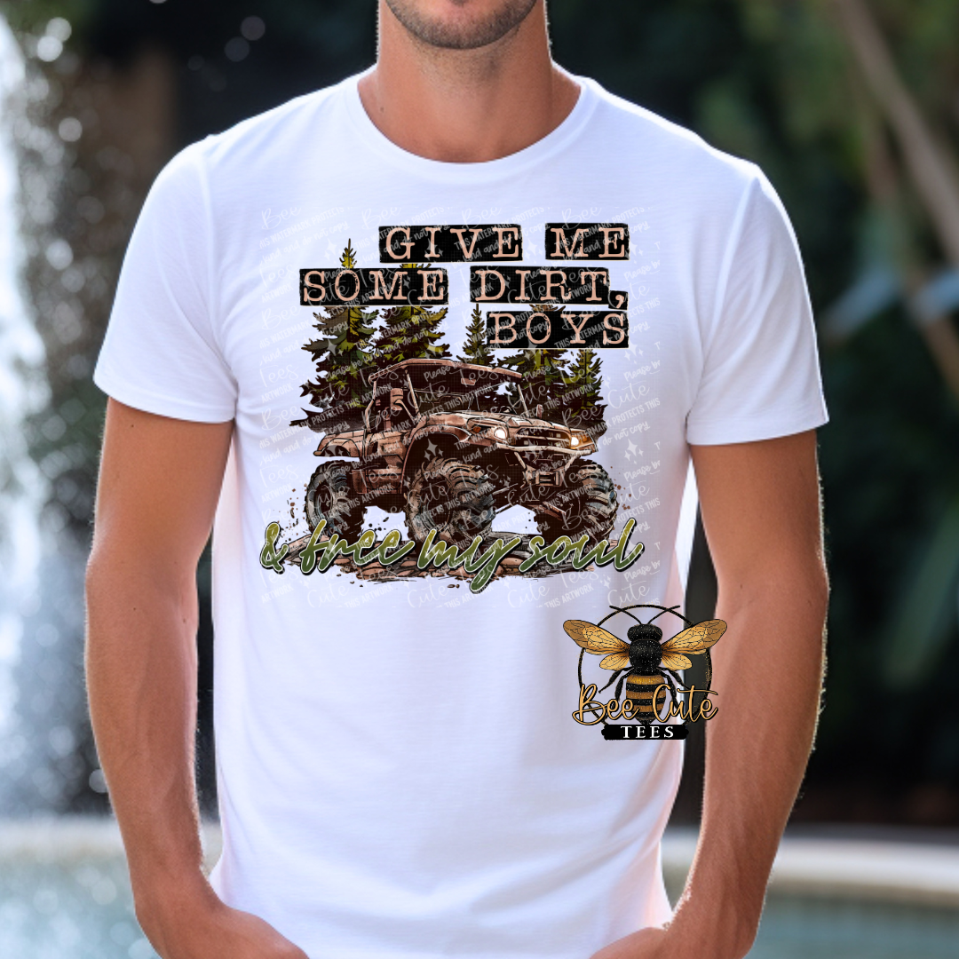 Man wearing a white graphic tee featuring a muddy off-road truck, pine trees, and the phrase “Give Me Some Dirt Boys” styled with a rugged country and outdoors theme.
