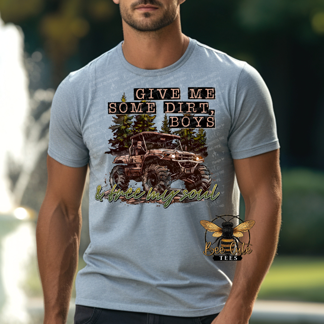 Man wearing a light gray graphic tee featuring a lifted mud truck in the woods with the phrase “Give Me Some Dirt, Boys” designed with an outdoors and off-roading theme.
