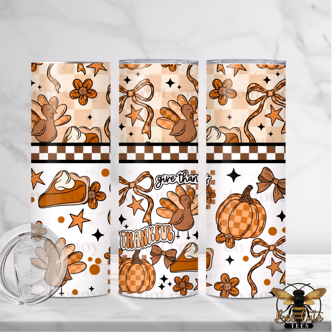 Three views of a playful Thanksgiving-themed 20 oz tumbler featuring cute cartoon turkeys, orange plaid pumpkins, pumpkin pie slices, bows, flowers, and stars. The design includes the phrases "Give Thanks" and "Thankful" with brown checkerboard accents and warm orange, tan, and cream colors.