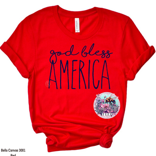 Red  t-shirt with a knotted front, featuring a navy “God Bless America” script design on the front.
