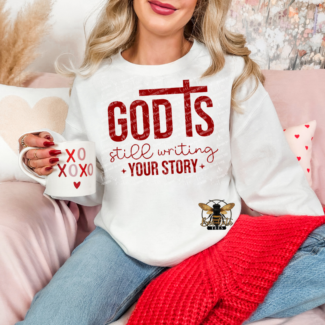 Person wearing a white sweatshirt with motivational text and holding a mug.