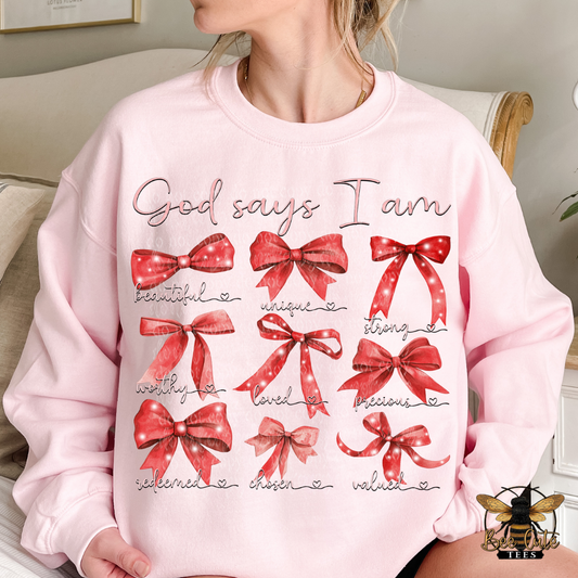 Pink sweatshirt with red bows and text on a neutral background