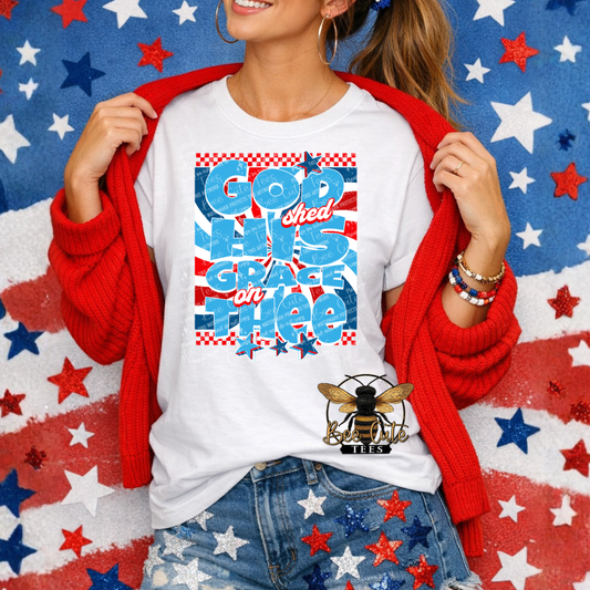Person wearing a white t-shirt with colorful text and graphics on a red, white, and blue star-patterned background.
