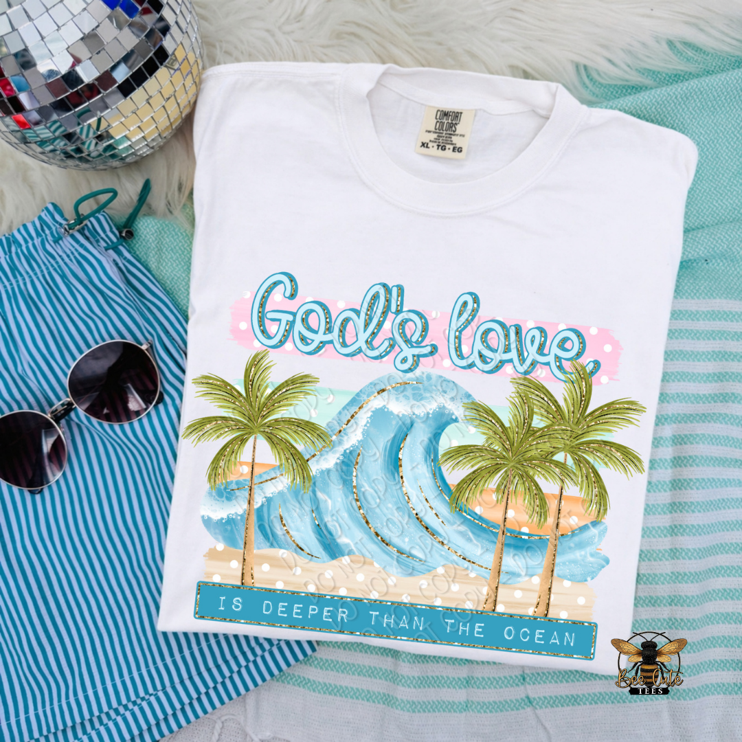 Folded t-shirt with 'God's love is deeper than the ocean' design on a striped fabric background