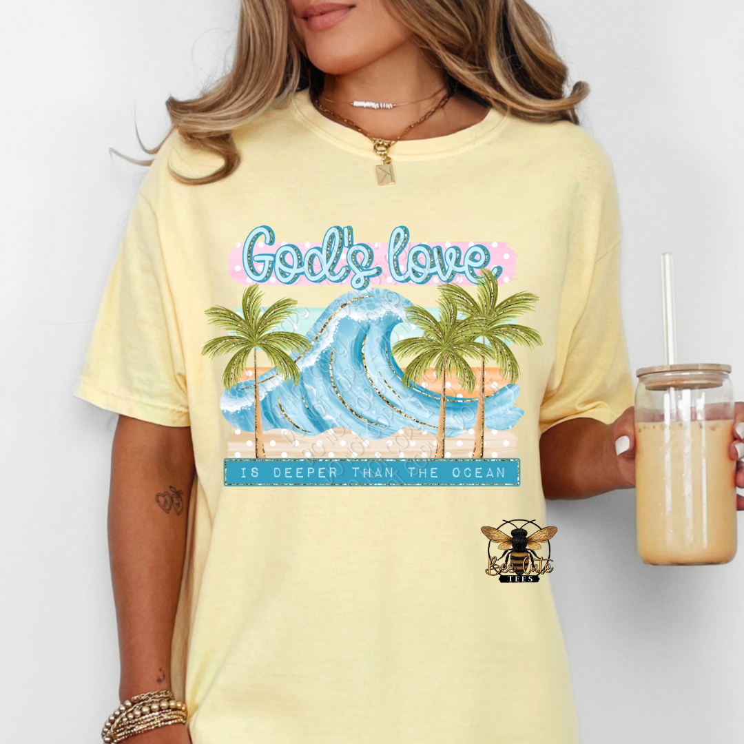 Person wearing a yellow t-shirt with a graphic design and text, holding a drink.