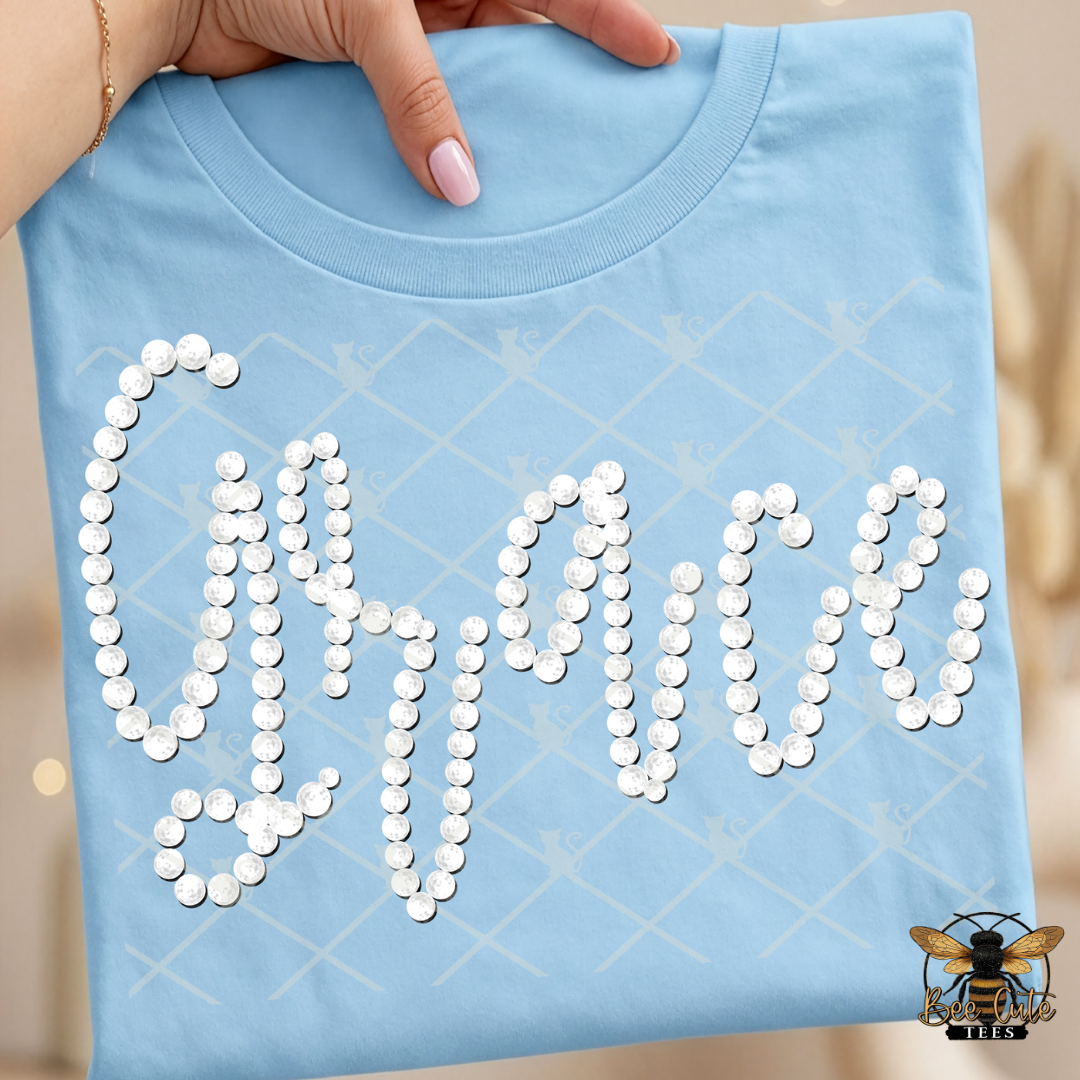 Light blue t-shirt with 'Grace' text made of faux white pearls held by a hand.