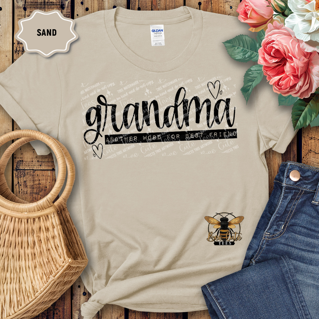 Beige t-shirt with 'grandma' graphic on a wooden surface with flowers and denim jeans.