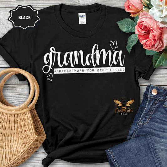 Black t-shirt with 'grandma another word for best friend' text, surrounded by flowers and jeans on a wooden surface.