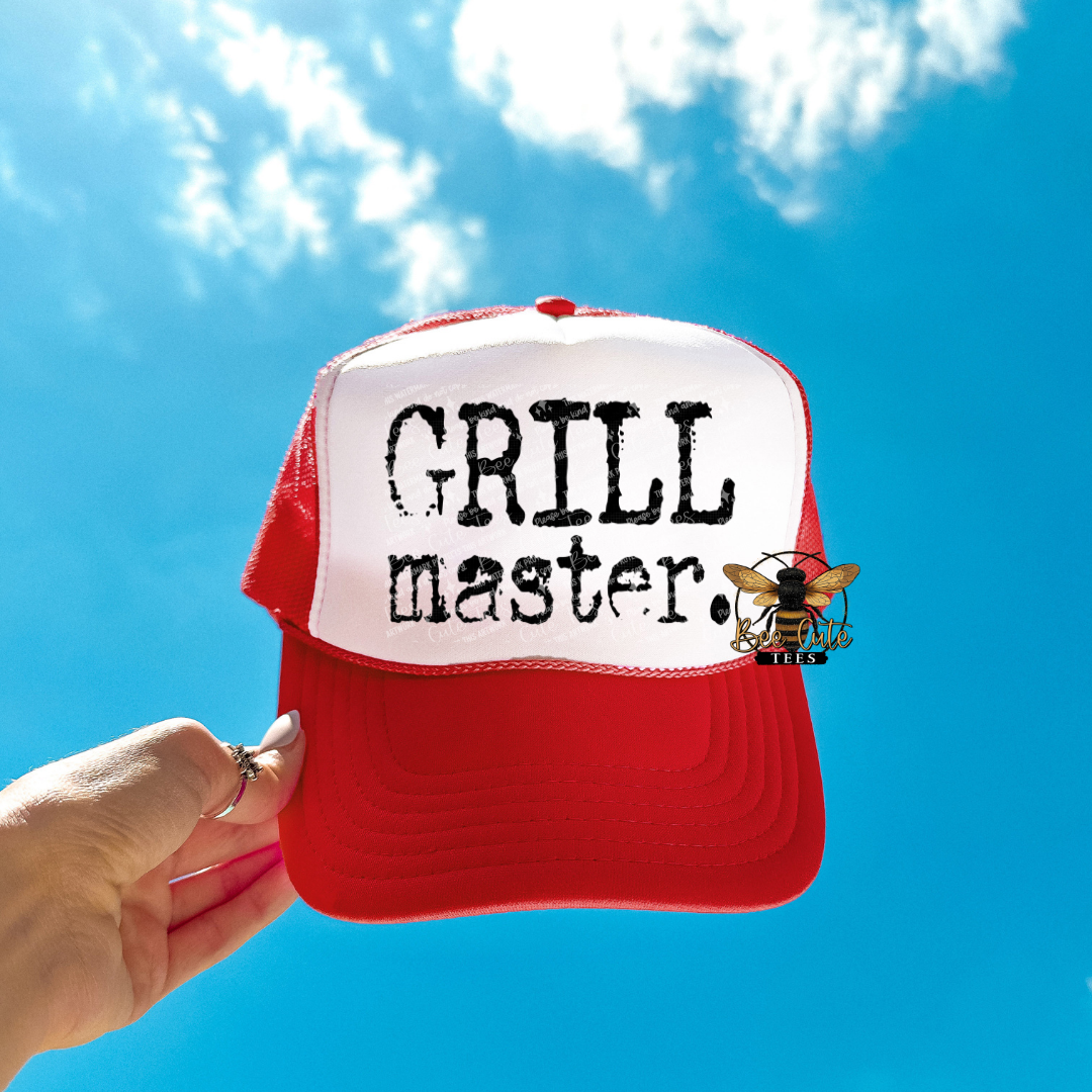Red and white cap with 'GRILL master' text against a blue sky