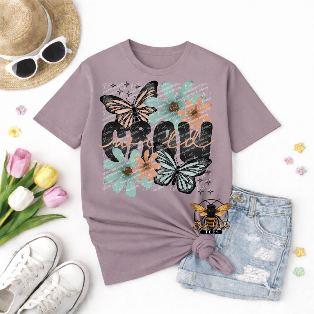 Purple t-shirt with butterfly and flower design, sunglasses, hat, tulips, and shorts on a white background