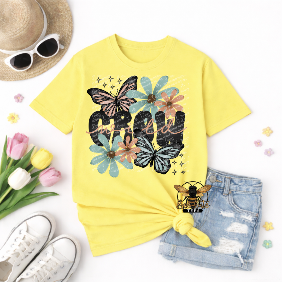 Yellow t-shirt with butterfly and floral design on a white background