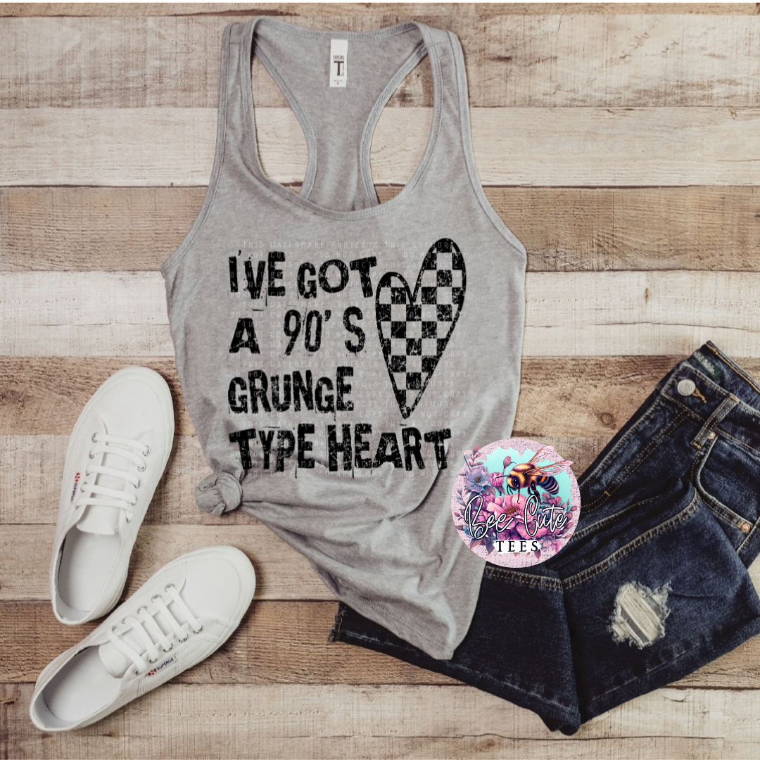 Gray tank top with text and heart design, paired with denim shorts and white sneakers on a wooden surface.