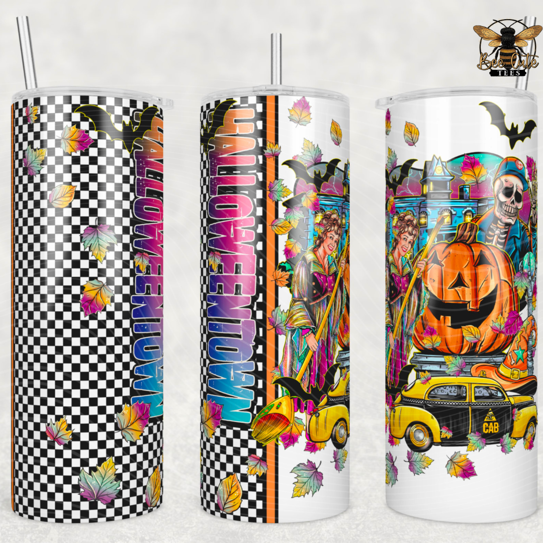 Three tall skinny tumblers with clear lids and metal straws, shown side by side on a light neutral background. Each tumbler features a colorful Halloween-themed wrap design: one checks black and white with pink text and autumn leaves, one has vertical pink text and witch imagery, and one shows a pumpkin, skeleton, witch, castle, and yellow car.
