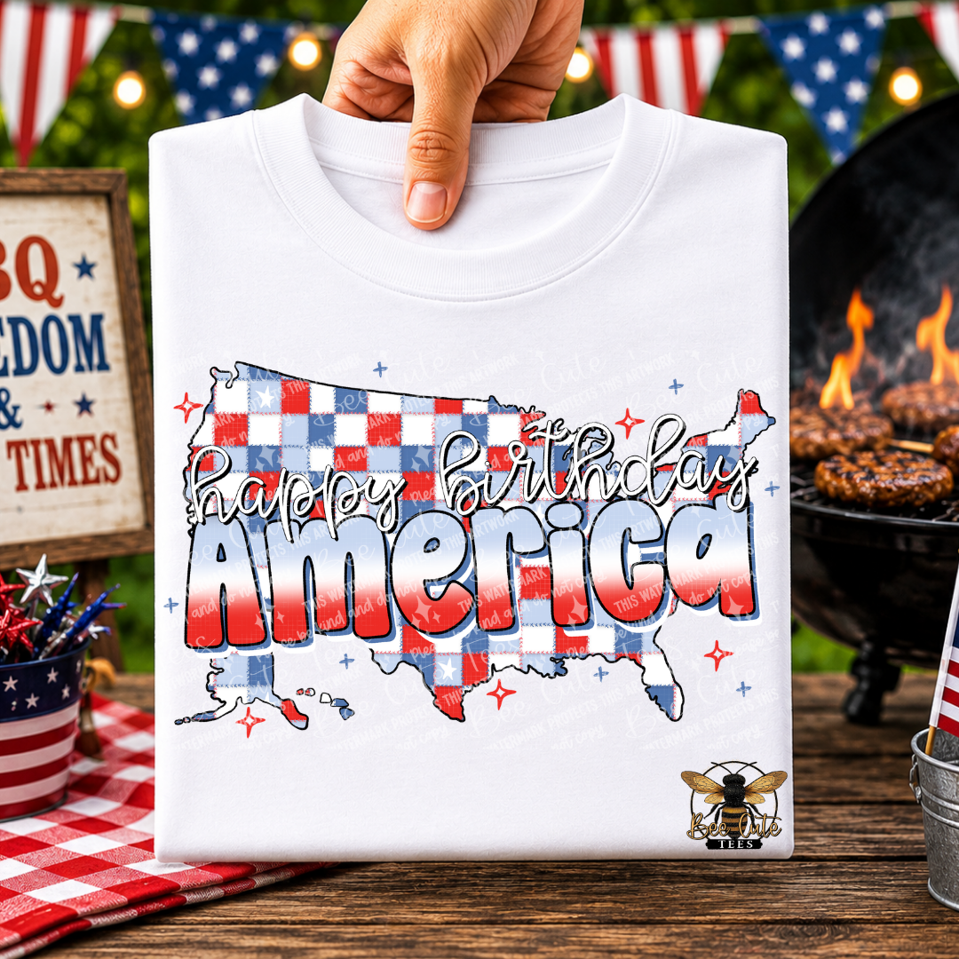 White t-shirt with 'Happy Birthday America' design held by a hand, with a festive background.