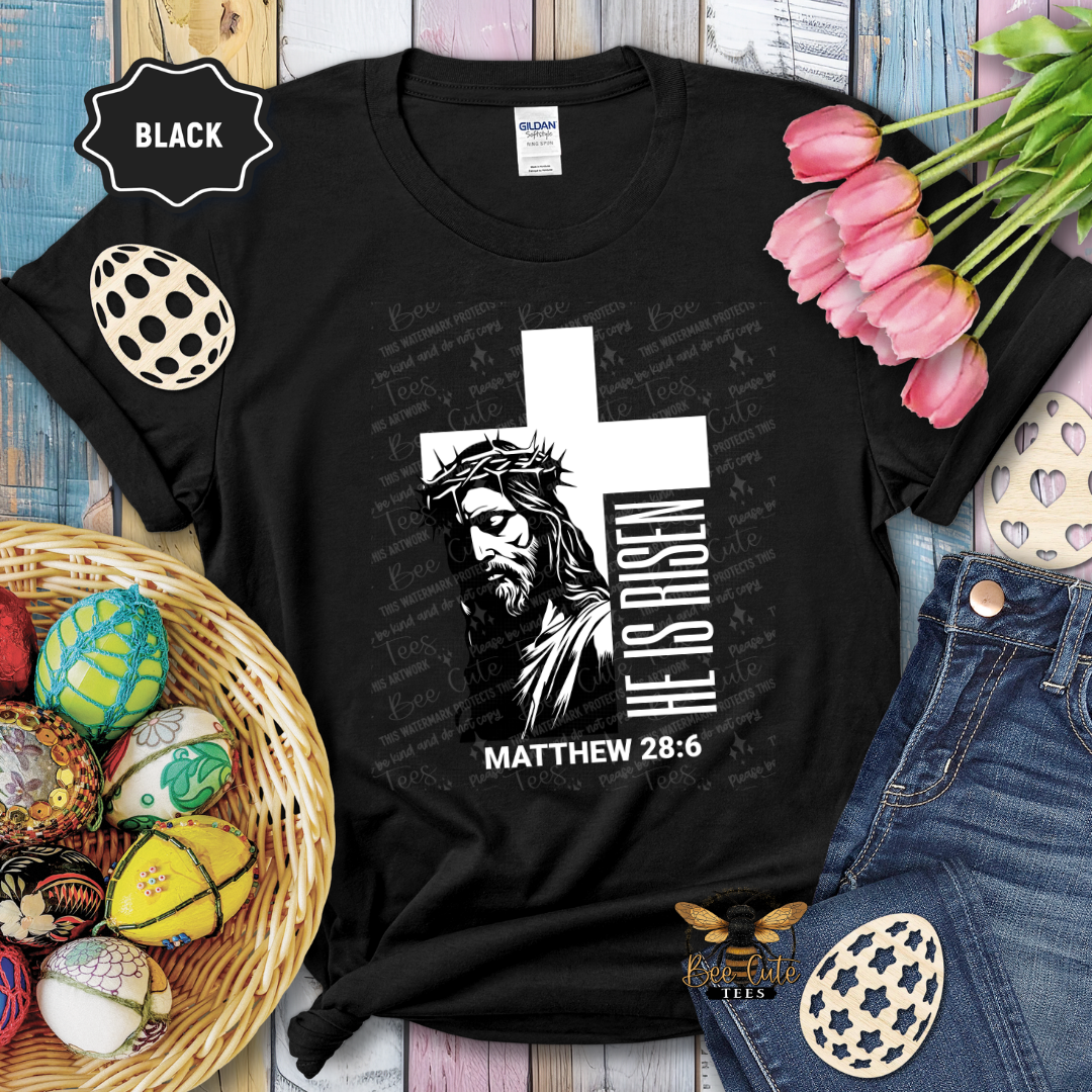 Black t-shirt with religious design featuring a cross and text, surrounded by Easter decorations.