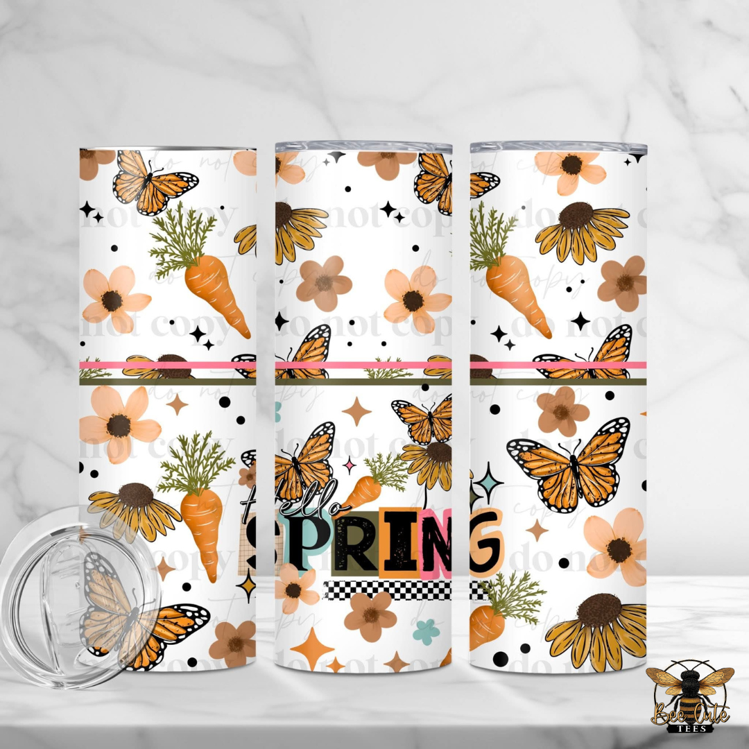 Three tumblers with spring-themed designs featuring butterflies, flowers, and carrots on a white background.