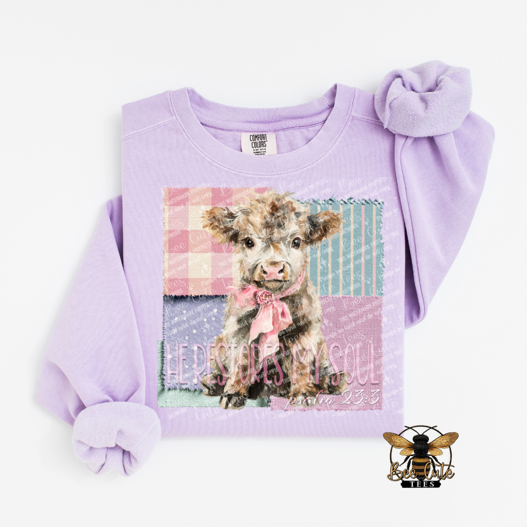Lavender sweatshirt with a graphic of a cow and text on a white background