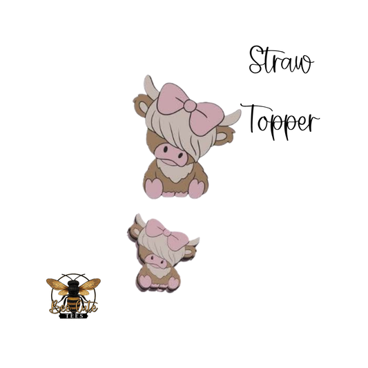 Two cow-shaped straw toppers with pink bows on a white background, labeled 'Straw Topper'.