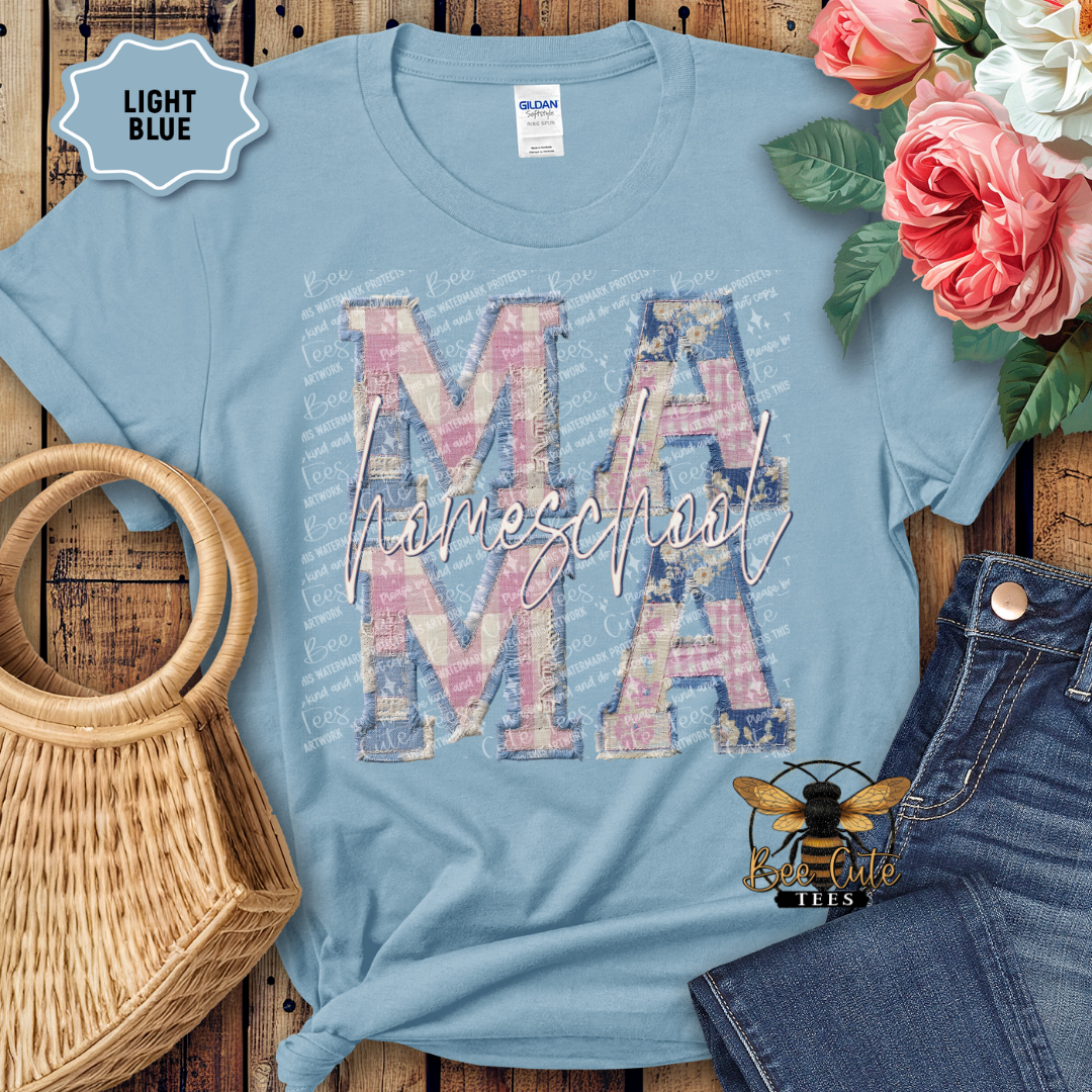 Light blue t-shirt with 'Homeschool Mama' design on a wooden surface with flowers and denim jeans.