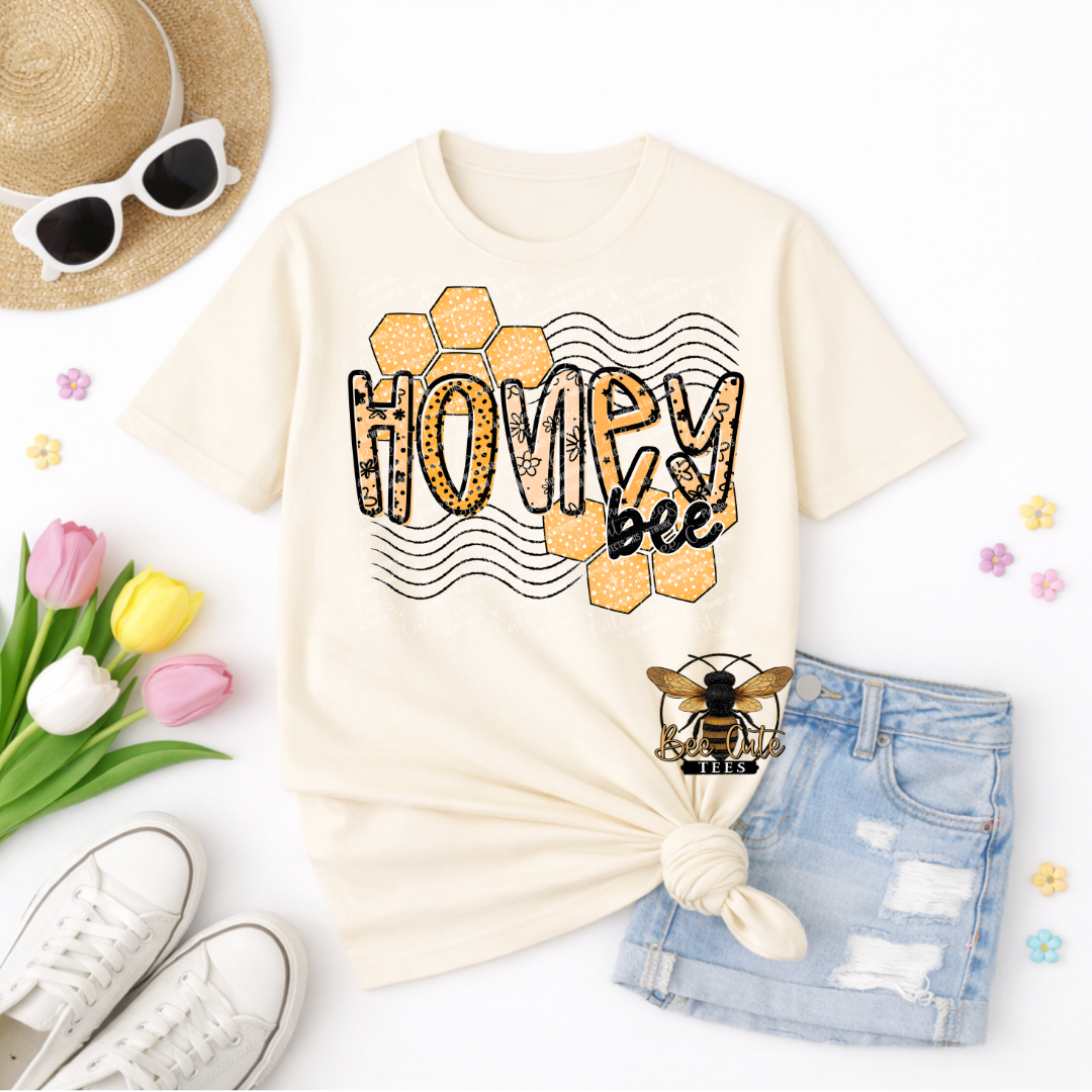 Beige t-shirt with 'Honey Bee' design, sunglasses, shorts, and flowers on a white background