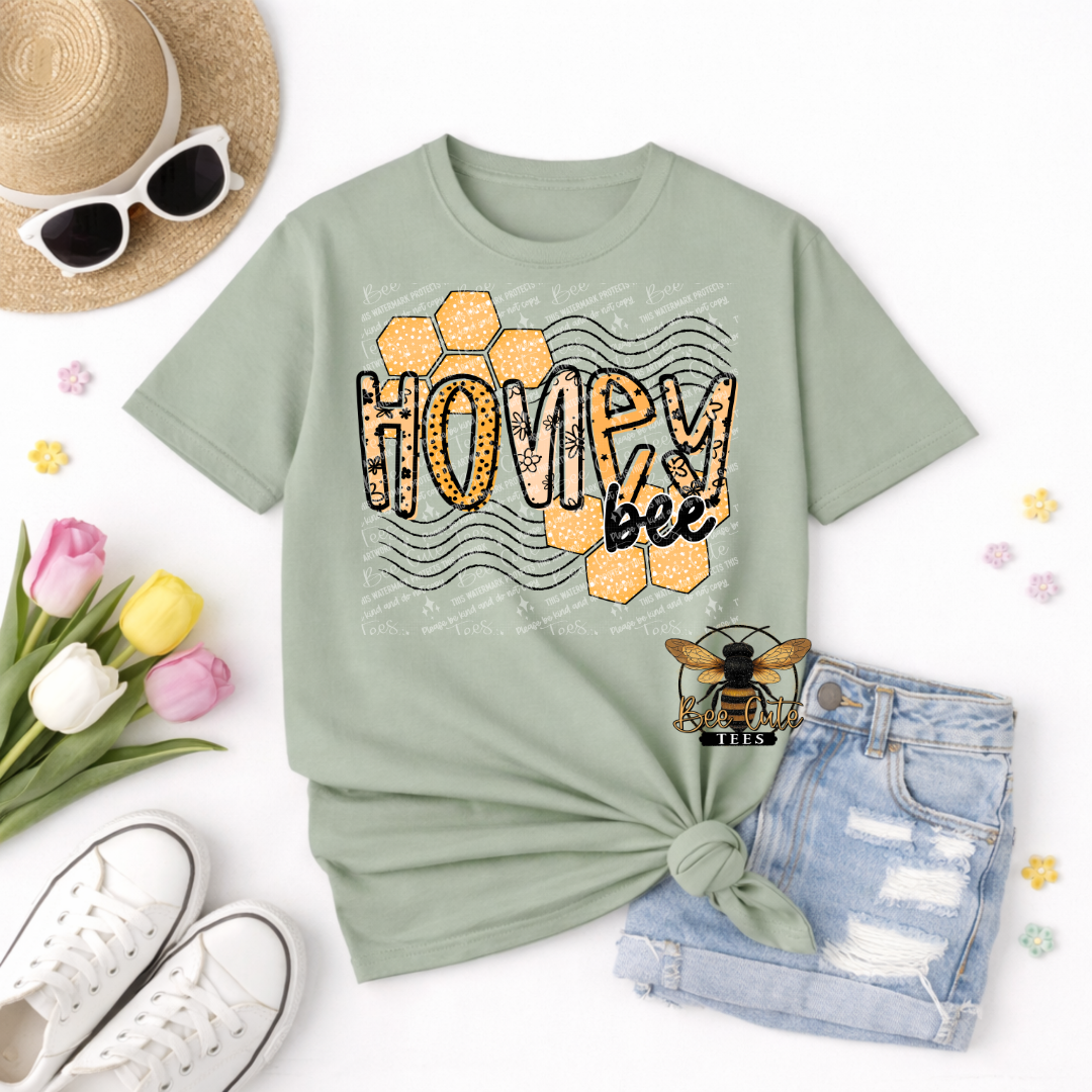 Light green t-shirt with 'Honey Bee' design, sunglasses, straw hat, tulips, and denim shorts on a white background