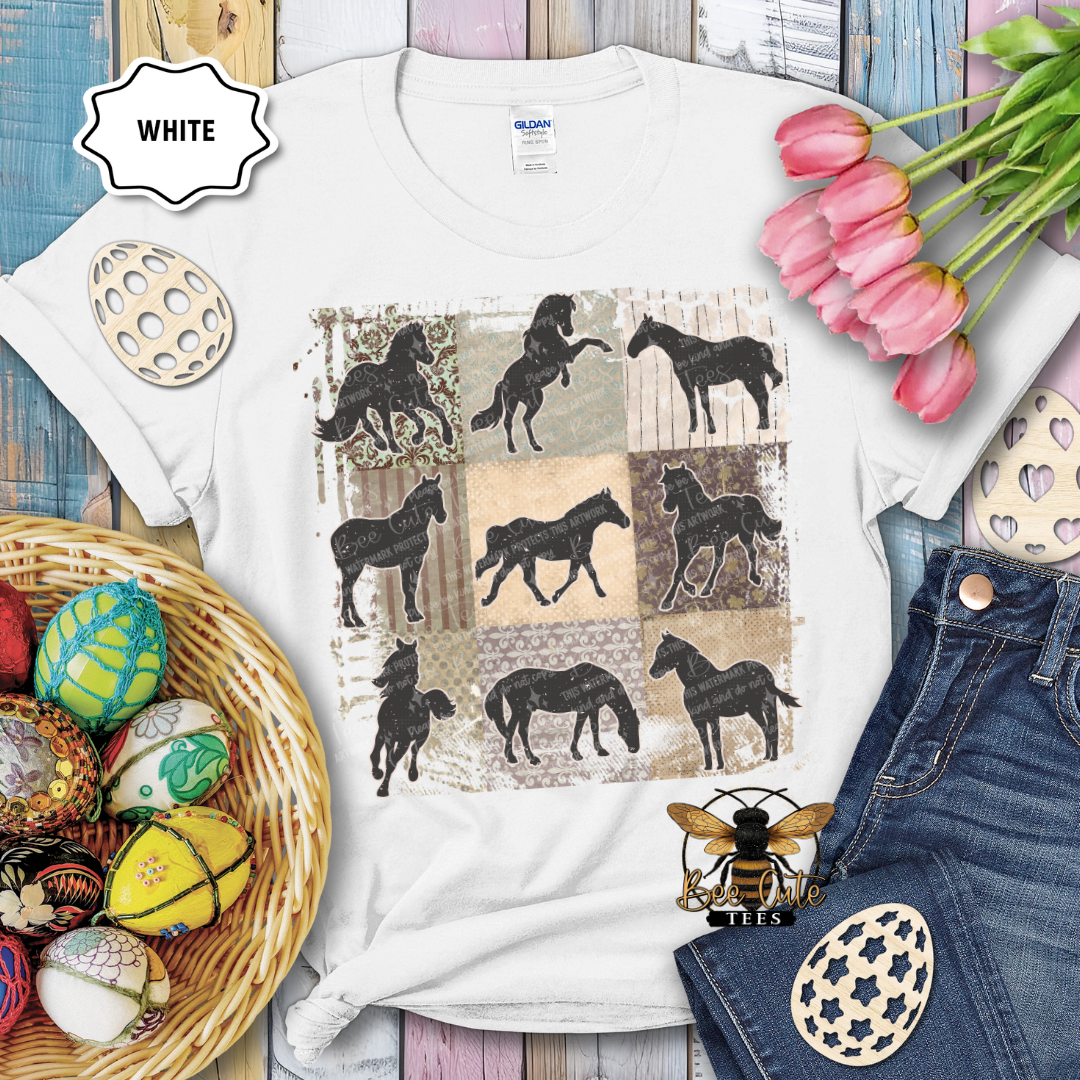 White t-shirt with horse design on a wooden surface with Easter decorations.