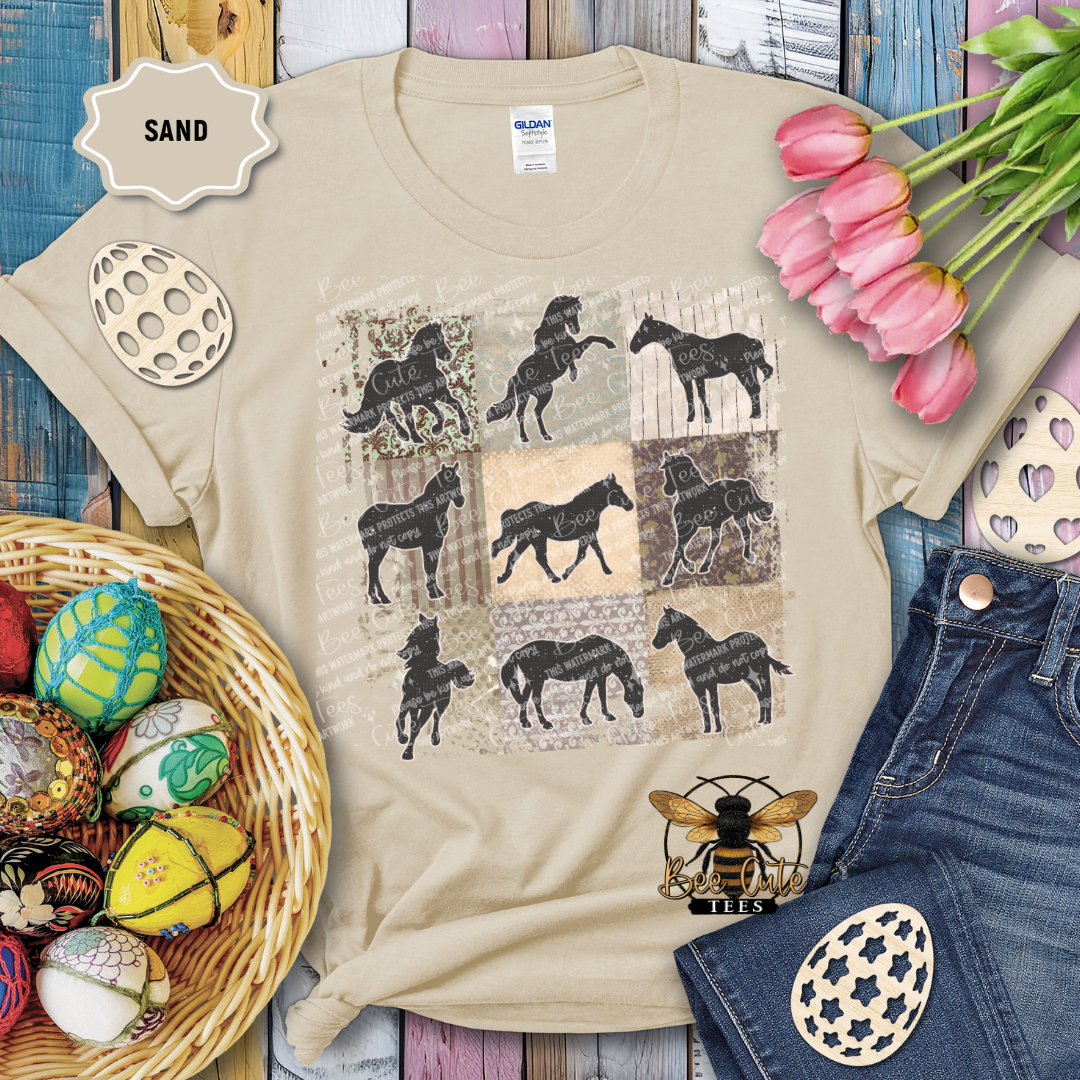 Beige t-shirt with horse pattern, surrounded by decorative items on a wooden surface.