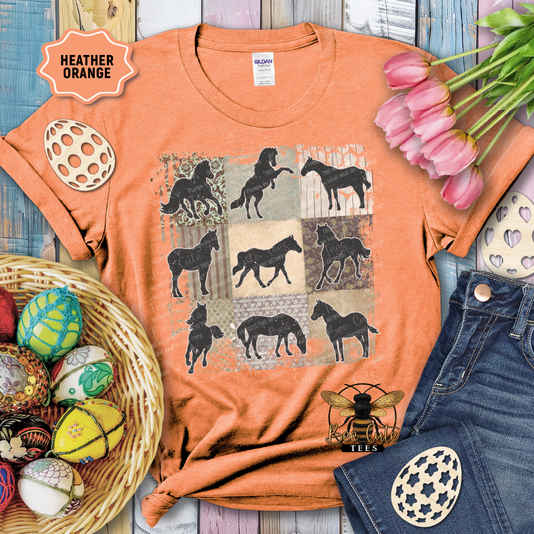 Orange t-shirt with horse design, surrounded by decorative items on a wooden surface.