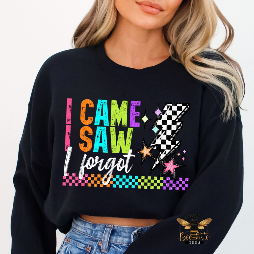Black sweatshirt with colorful text and graphics worn by a person, brand 'Bee Cute Tees' visible.