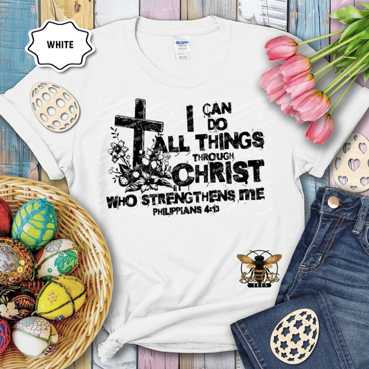 White t-shirt with motivational quote, surrounded by Easter decorations on a wooden surface.