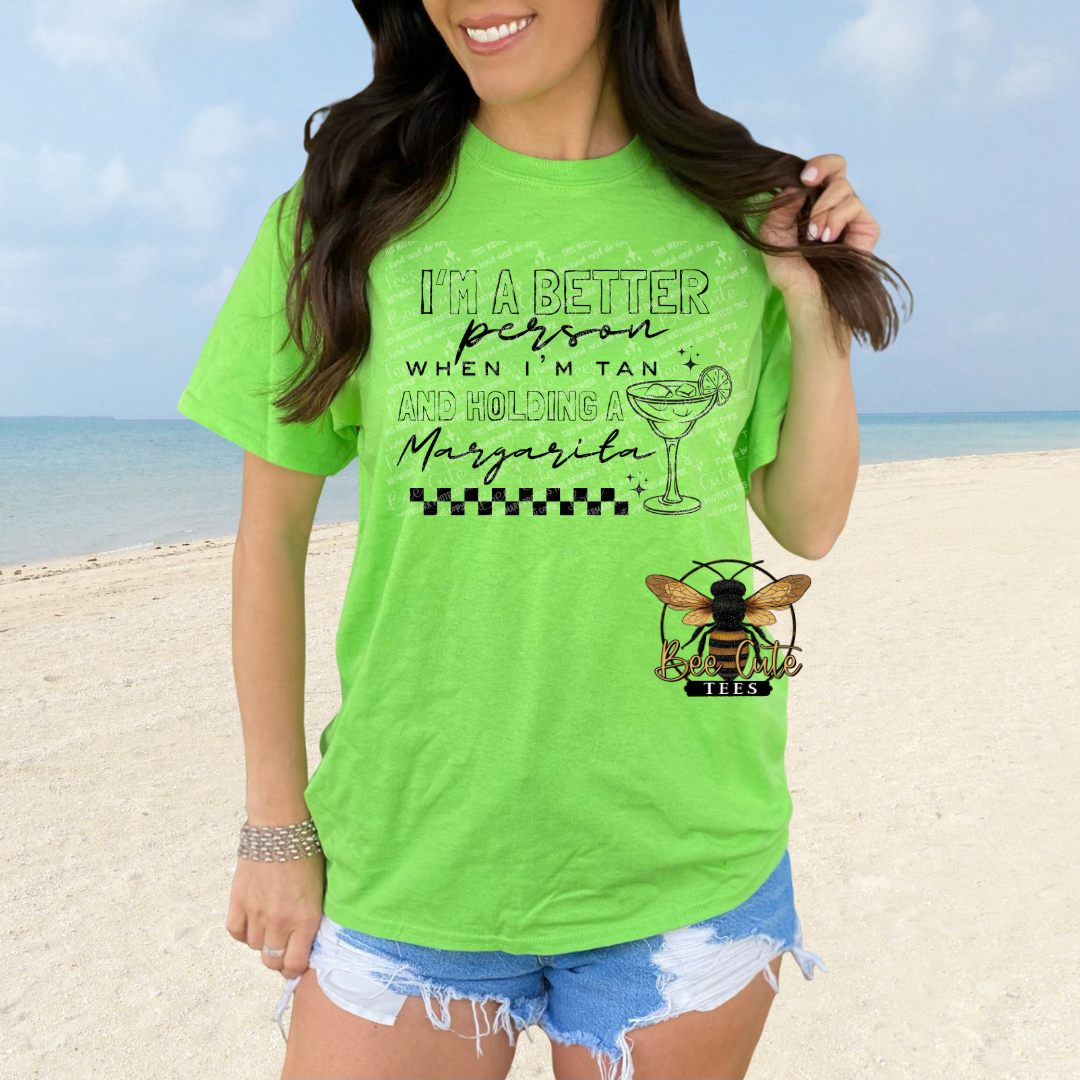 Person wearing a bright green t-shirt with a beach background