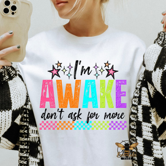 Person wearing a white sweatshirt with colorful text design and a phone in hand.