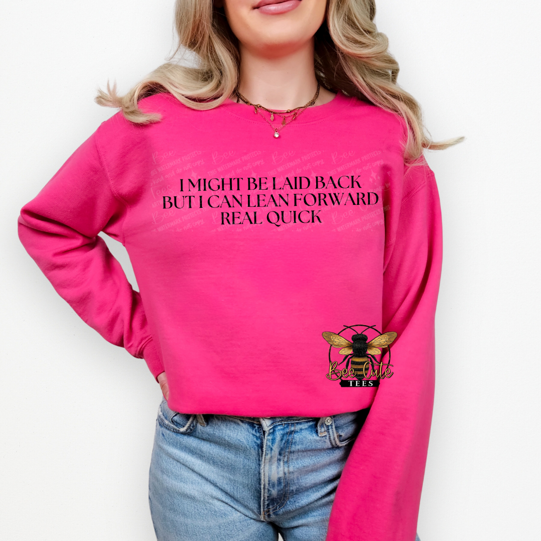 Person wearing a pink sweatshirt with text and a bee graphic on a white background