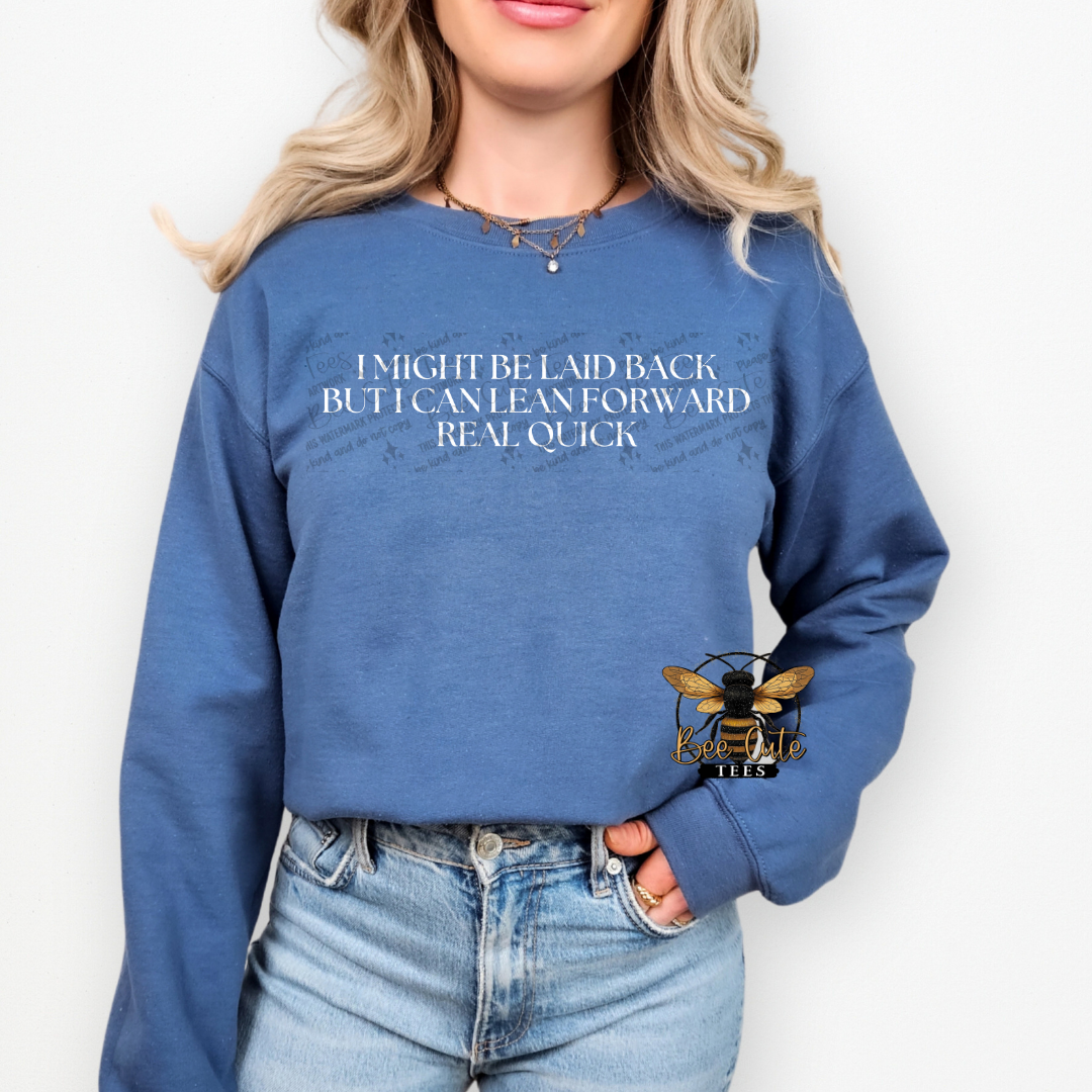 Person wearing a blue sweatshirt with humorous text and a logo on a white background