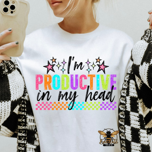 Person wearing a white sweatshirt with colorful text 'I'm Productive in my Head' and a logo on a light background.