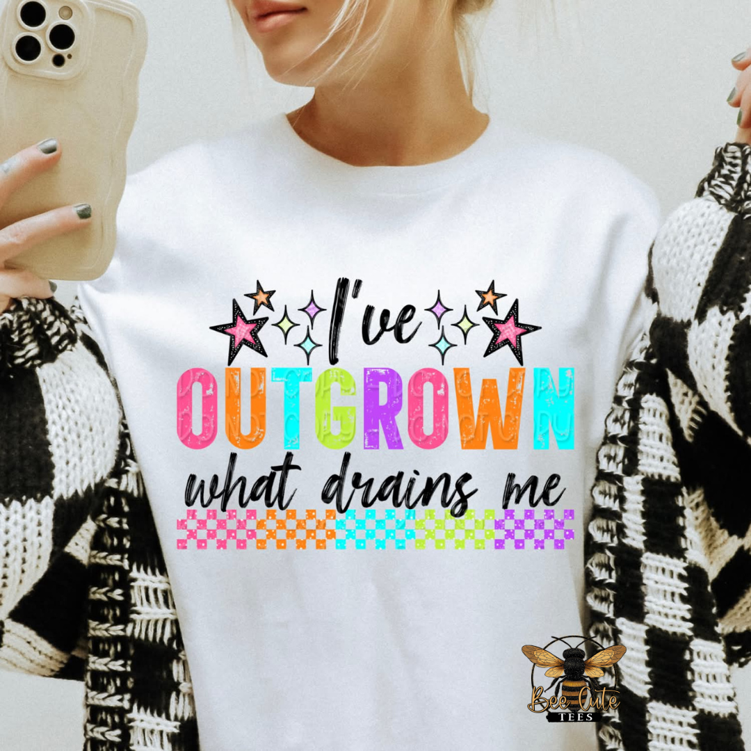 Person wearing a white sweatshirt with colorful text design.