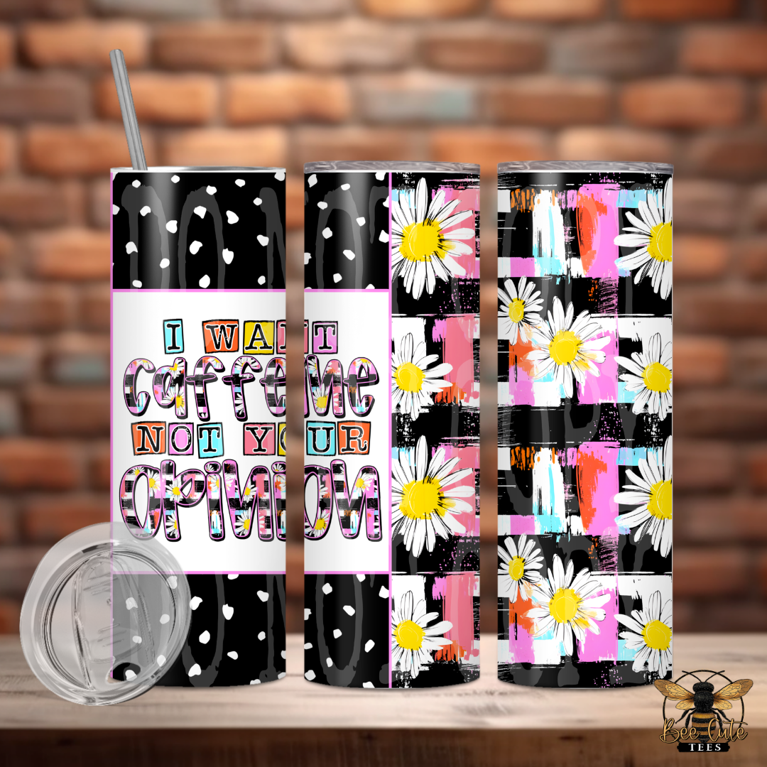 Three tumblers with different designs on a wooden surface with a brick wall background.