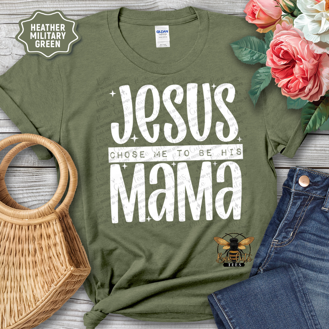 Green t-shirt with 'Jesus Chose Me to be His Mama' text, surrounded by flowers and jeans on a wooden surface.