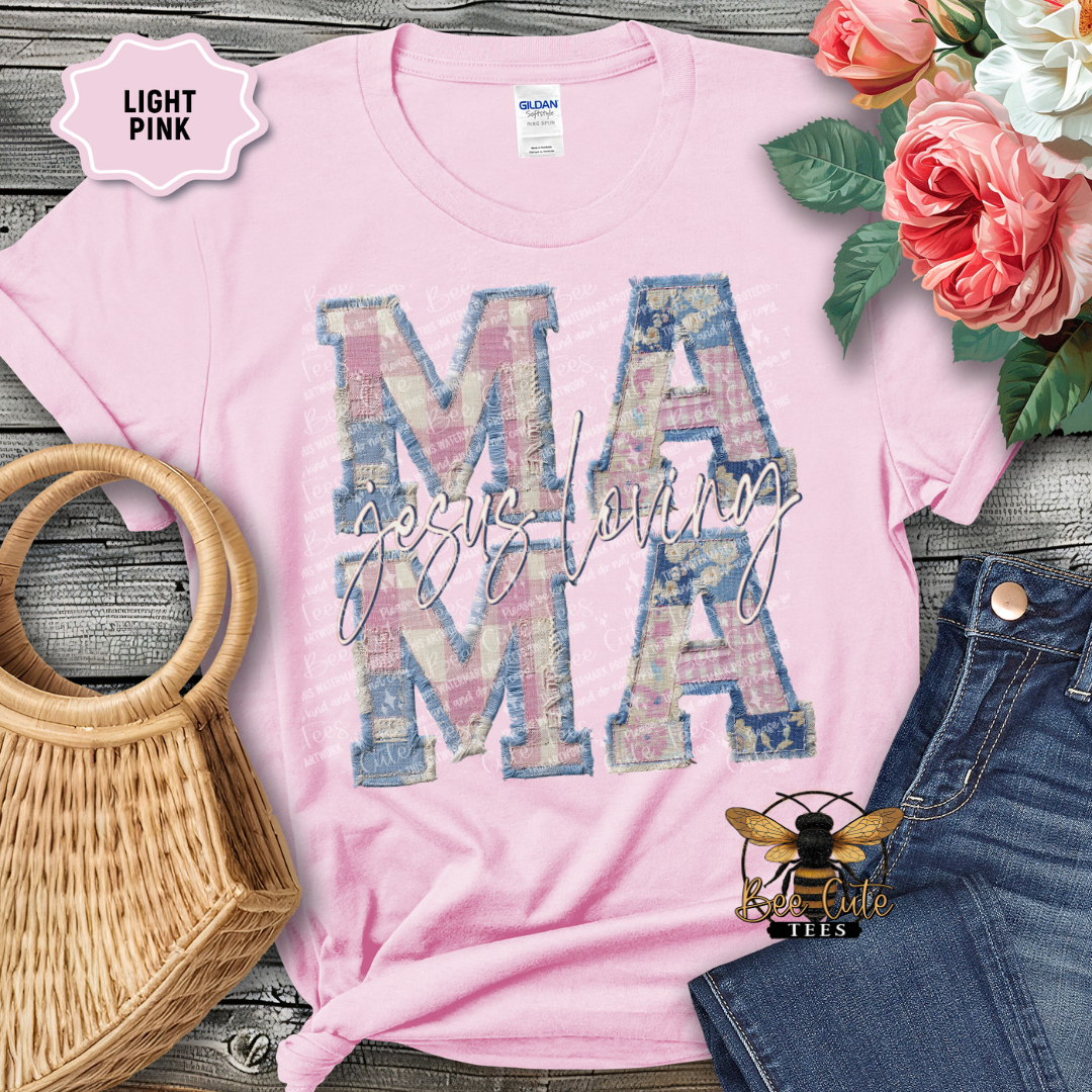 Pink t-shirt with 'MAMA' design on a wooden surface with flowers and denim jeans.