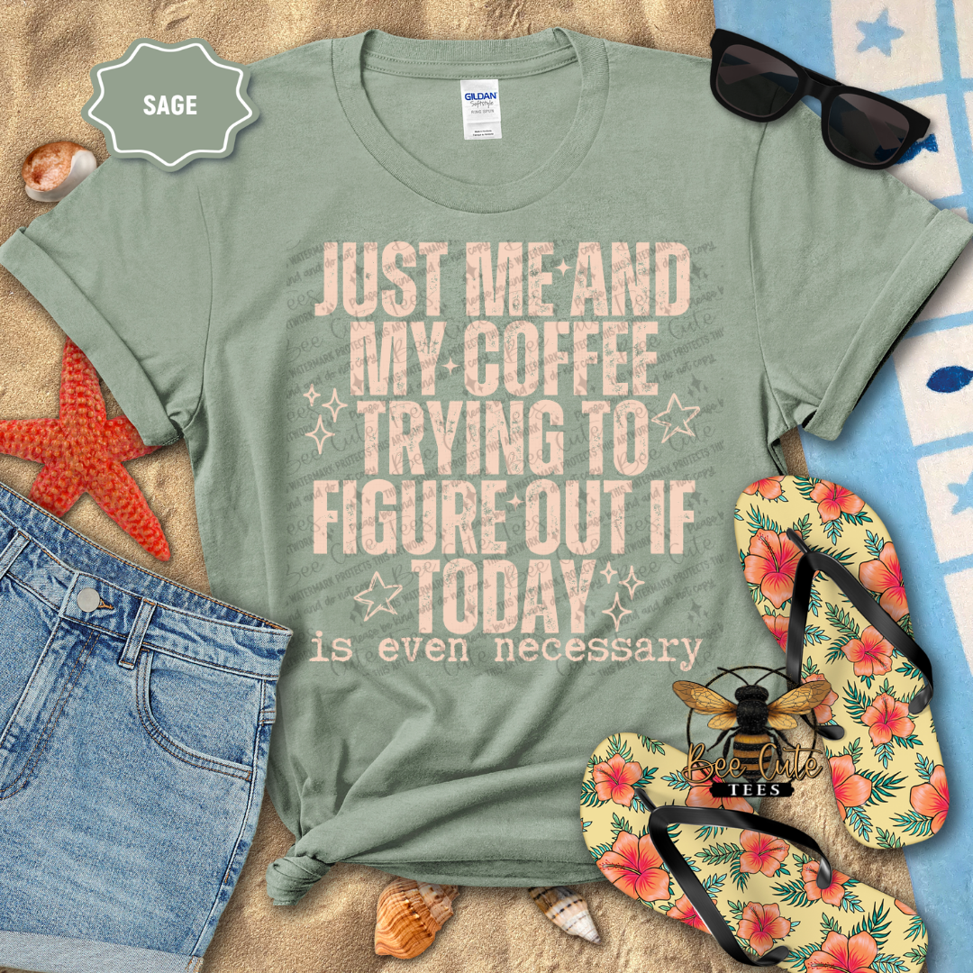 Sage green t-shirt with text 'Just me and my coffee trying to figure out if today is even necessary' on a beach setting with sunglasses, flip-flops, and starfish.