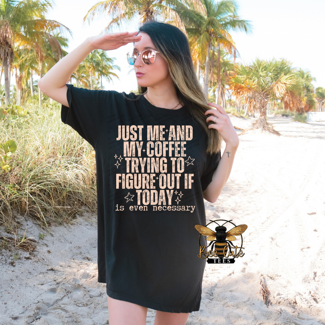Woman wearing a black t-shirt with a humorous quote on a beach.