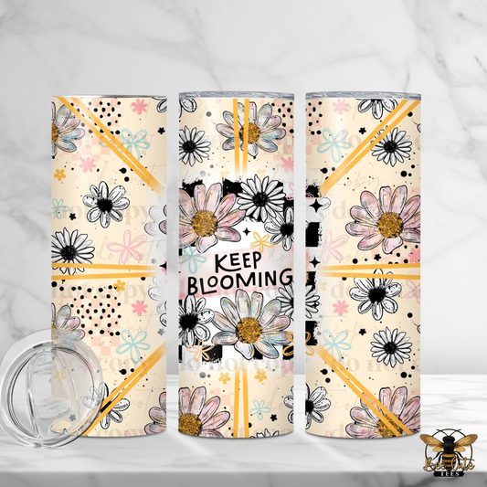 Three tumblers with floral designs and 'Keep Blooming' text on a white background
